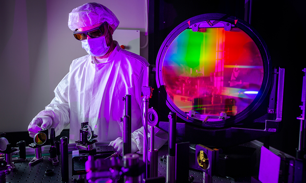 Scientist in lab reviews samples for the Laser Damage Competition