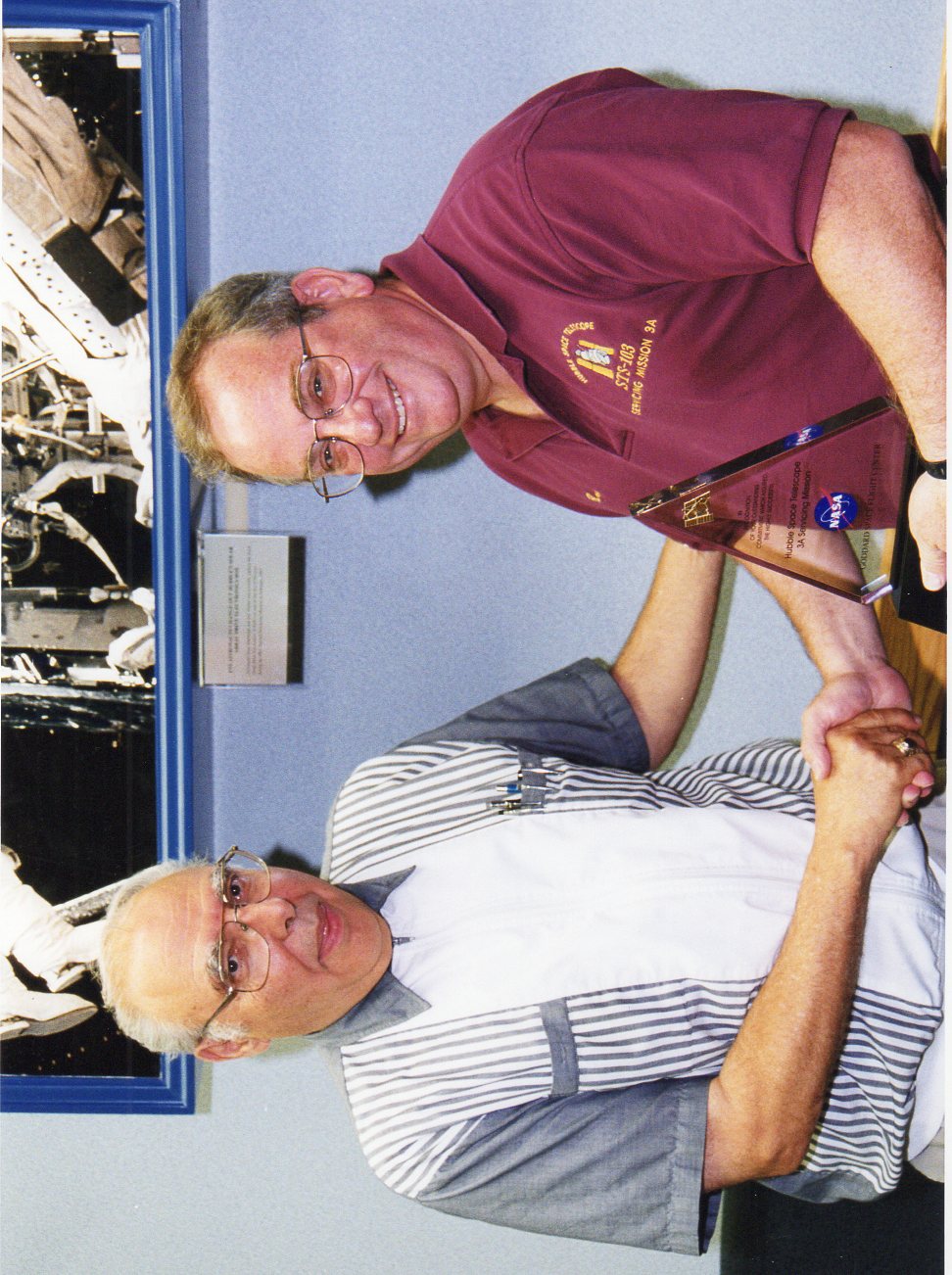 Barasch receiving an award from HST project manager, Frank Cepollina, shortly after a Hubble servicing mission by a NASA space shuttle in 1999.