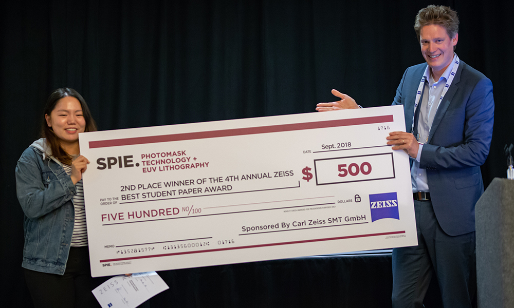 Award winner receives an oversized check at the conference