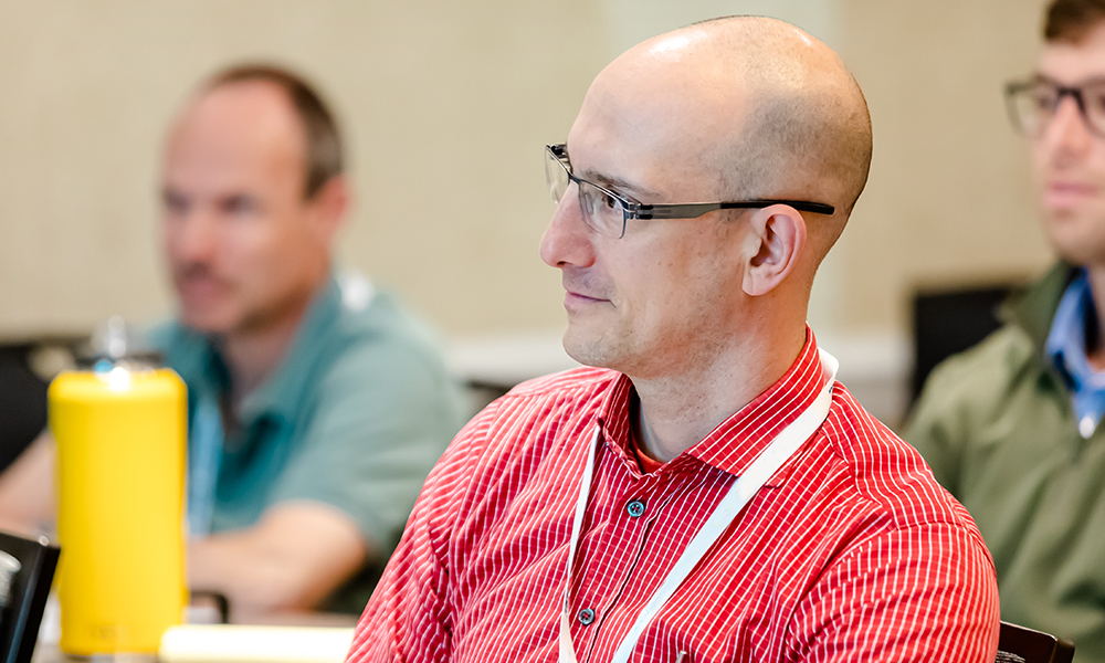 A man sits in a classroom to learn about systems engineering for an astronomical telescope