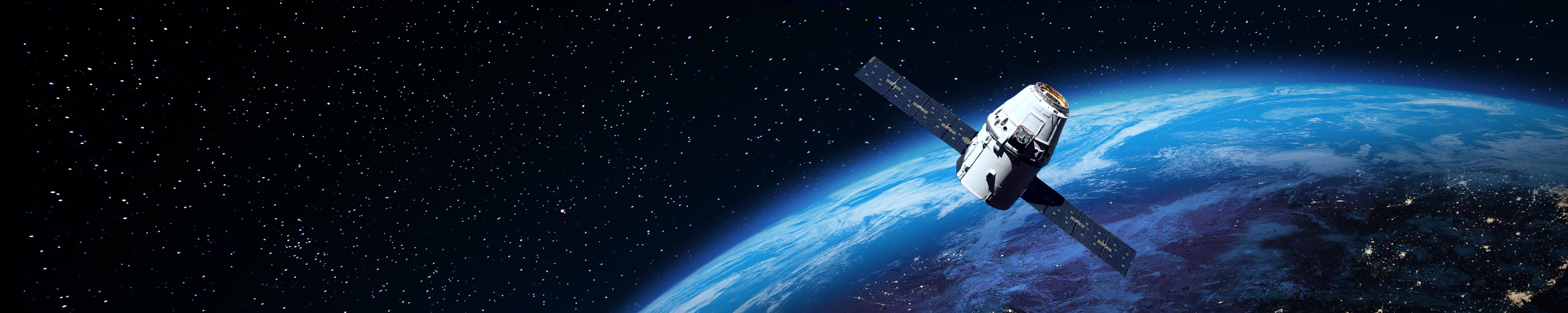 Satellite orbiting above Earth with extended solar panels, overlooking the planet’s illuminated surface against a star-filled space backdrop.