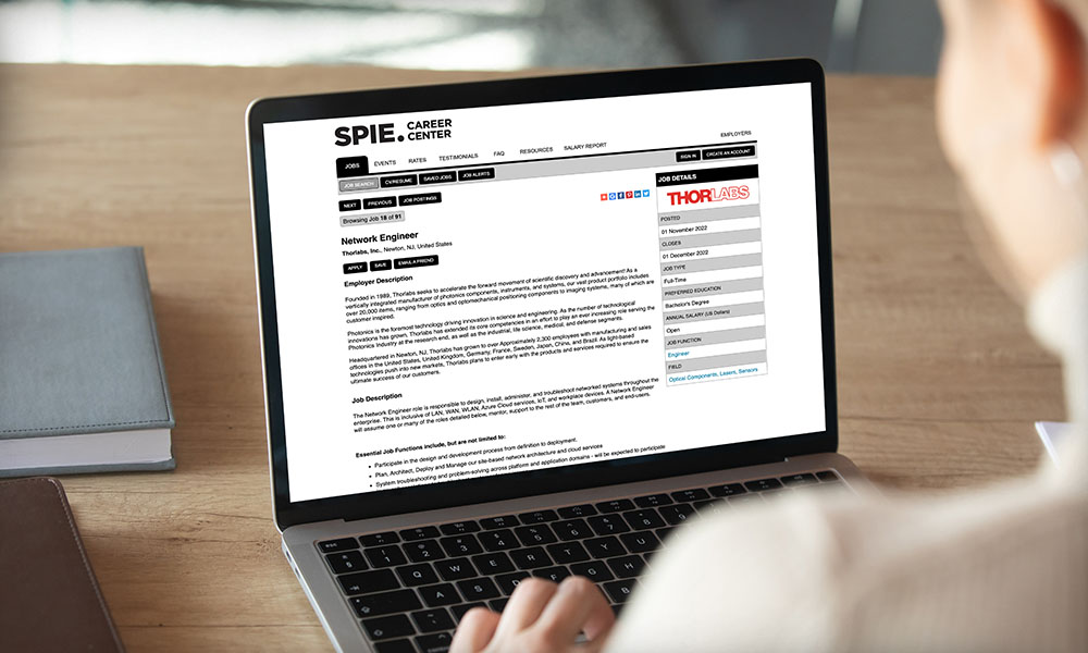 Woman looking at a computer screen on the SPIE Career Center Website