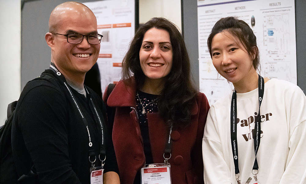 Three students at an SPIE event