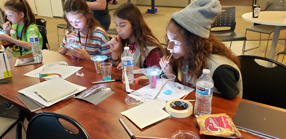 Girls get an introduction to thin film interference while having fun with bubbles 