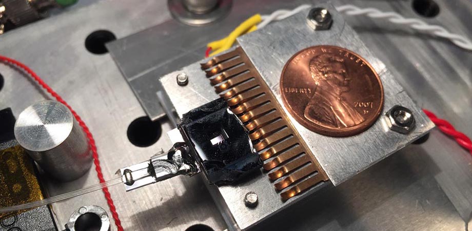This NIST-developed chip squeezes a tiny cloud of atoms and structures for guiding light waves into an area of less than a single square centimeter.
