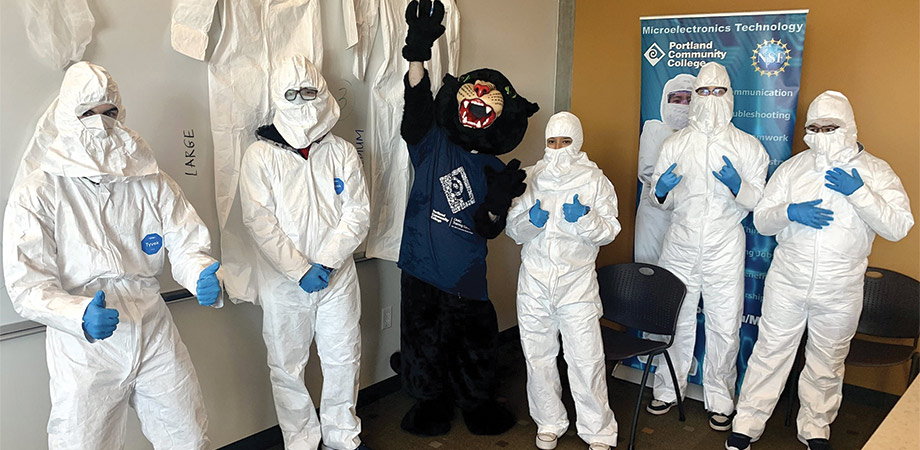 Quick Start students practicing wearing “bunny suits” worn by manufacturing technicians at Intel, alongside Portland Community College mascot Poppie the Panther. Credit: Intel.
